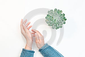 Closeup of hands of a young woman with manicure on nails against white background