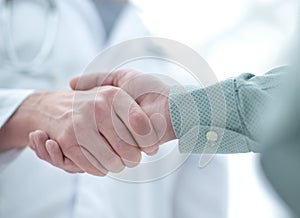 Closeup.handshake between doctor and patient.