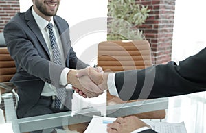 Closeup. handshake between the financial Manager and the client