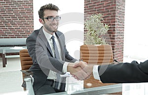 Closeup. handshake between the financial Manager and the client