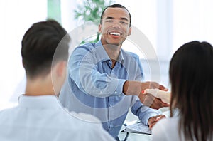 Closeup.handshake Manager and the client in the office