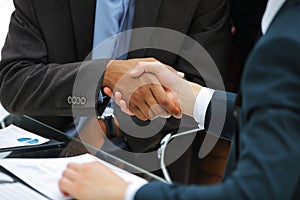 Closeup.handshake trading partners on the background of the workplace