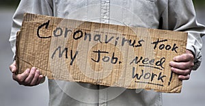 Closeup handwritten cardboard sign, Coronavirus Took My Job, man`s hands, unemployed, downsized, job