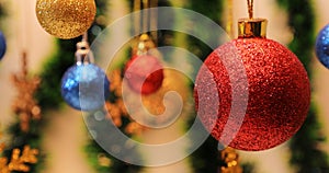 Closeup of hanging red Christmas ball. Christmas decorations traditional ornaments.