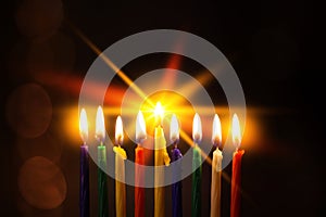 Closeup of Hanukkah menorah, or hanukkiah for Jewish holiday Hanukkah. Nine colored candles.