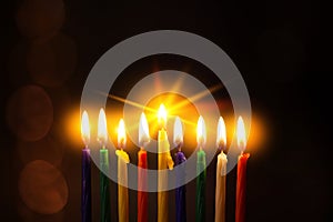 Closeup of Hanukkah menorah, or hanukkiah for Jewish holiday Hanukkah. Nine colored candles.