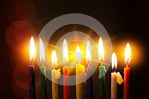 Closeup of Hanukkah menorah, or hanukkiah for Jewish holiday Hanukkah. Nine colored candles.