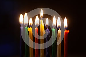 Closeup of Hanukkah menorah, or hanukkiah for Jewish holiday Hanukkah. Nine colored candles.