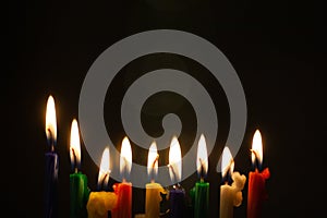 Closeup of Hanukkah menorah, or hanukkiah for Jewish holiday Hanukkah. Nine colored candles.