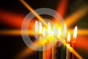 Closeup of Hanukkah menorah, or hanukkiah for Jewish holiday Hanukkah. Nine colored candles. Selective focus.