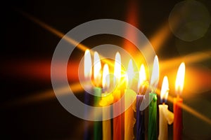 Closeup of Hanukkah menorah, or hanukkiah for Jewish holiday Hanukkah. Nine colored candles. Selective focus.