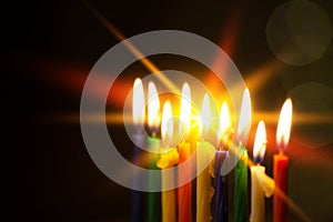 Closeup of Hanukkah menorah, or hanukkiah for Jewish holiday Hanukkah. Nine colored candles. Selective focus.