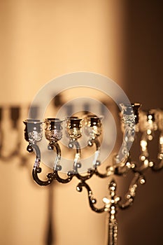 Closeup of Hanukkah menorah, or hanukkiah in the light of the sun at sunset for Jewish holiday Hanukkah.