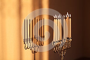 Closeup of Hanukkah menorah, or hanukkiah in the light of the sun at sunset for Jewish holiday Hanukkah.