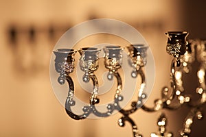 Closeup of Hanukkah menorah, or hanukkiah in the light of the sun at sunset for Jewish holiday Hanukkah.