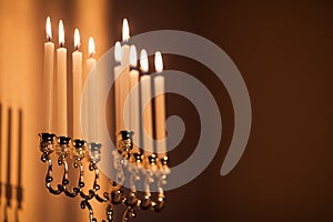 Closeup of Hanukkah menorah, or hanukkiah in the light of the sun at sunset for Jewish holiday Hanukkah.