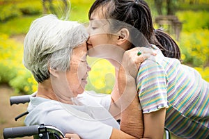 Closeup,Happy asian elderly woman with beautiful child girl hugging,kissing,smiling in summer,love of granddaughter with senior