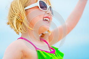 Closeup on happy baby girl in sunglasses