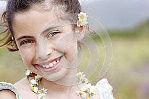 Closeup Of Happy Cute Little Girl In Flower Necklace