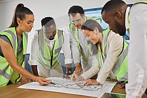 Closeup of a happy diverse multiracial group of architect colleagues analyzing a blueprint design on a building and