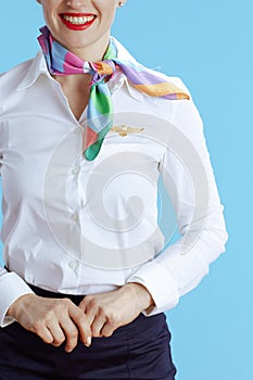 Closeup on happy elegant air hostess woman on blue