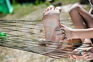 Closeup of happy family lying on hammock on sunny countryside background.