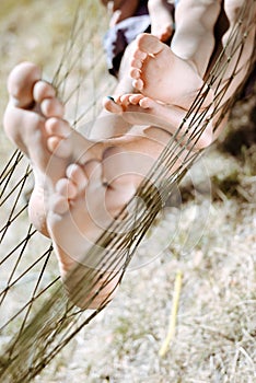 Closeup of happy father and child barefoot feet in