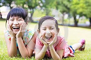 Closeup happy little girls on the grass