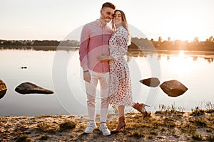 Closeup of happy loving couple spending leisure time together at beach. couple in love by the water. warm summer day