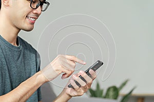 Closeup of happy man using a smartphone , searching, browsing, social media, message, email, internet digital marketing, online