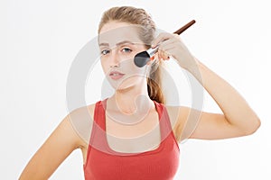 Closeup of happy young woman face with make up brush isolated on white background. Beauty girl skin care concept. Copy space