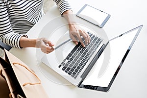 Closeup of happy young woman holding credit card inputting card