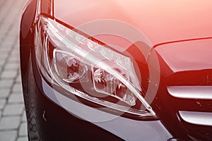 Closeup headlight luxury sedan car