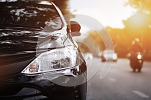 Closeup headlights of black car.