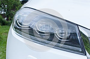 Closeup headlights of car. Car exterior detail