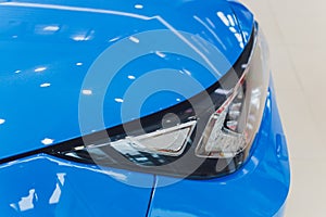 Closeup headlights of car white body close-up. blue body