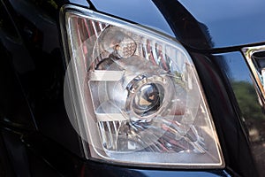 Closeup headlights of modern black car