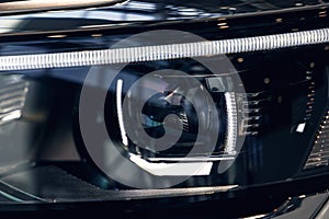 Closeup headlights of a modern car. Detail on the front light of a car