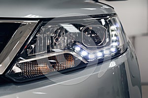 Closeup headlights of a modern car. Detail on the front light of a car