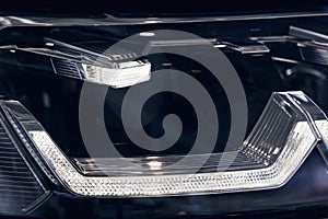 Closeup headlights of a modern car. Detail on the front light of a car