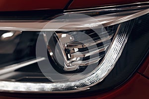 Closeup headlights of a modern car. Detail on the front light of a car