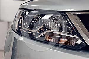 Closeup headlights of a modern car. Detail on the front light of a car. Modern and expensive car concept