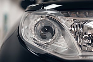 Closeup headlights of a modern car. Detail on the front light of a car. Modern and expensive car concept