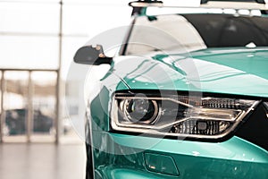 Closeup headlights of a modern Mint color car