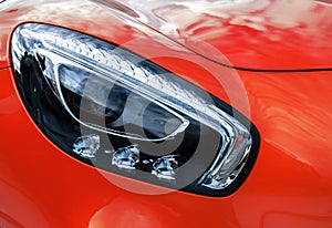 Closeup headlights of modern sport yellow car. Car exterior deta