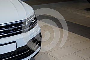 Closeup headlights of a modern white color car. Detail on the front light of a car