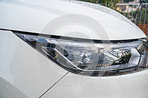 Closeup headlights of white car, Modern car`s headlight design