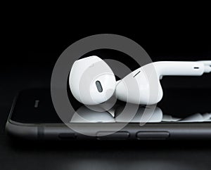 Closeup headphone on phone black background
