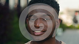 Closeup headshot African American cheerful positive happy smiling guy ethnic biracial man millennial male smile toothy