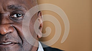 Closeup headshot half male face portrait serious mature African man middle-aged architect expert boss old elder